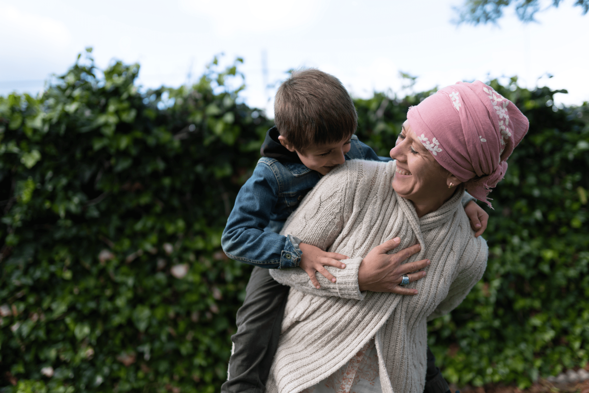 Happy woman giving grandson a piggy-back ride
